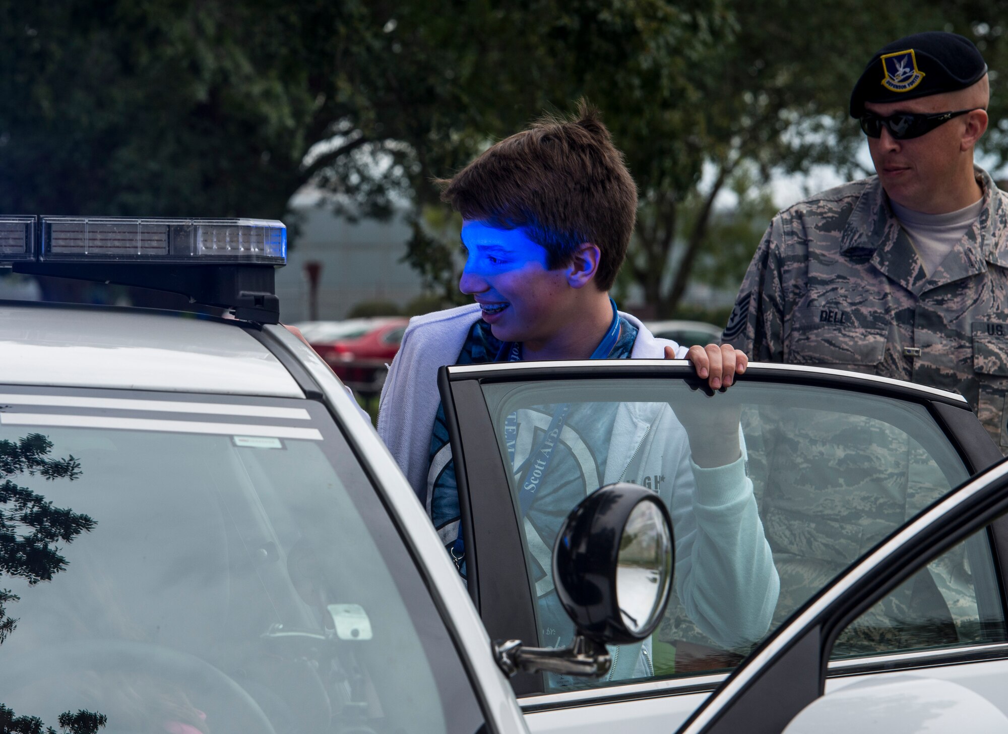 Tech. Sgt. Bryan Dell, 375th Security Forces Squadron, shows a middle school student the working of his patrol car on Scott Air Force Base, Ill., Sept. 29, 2016.  