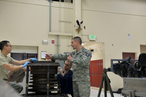 U.S. Air Force Tech. Sgt. Daniel Campanella, an Air Education and Training Command aerospace propulsion instructor with the 372nd Training Squadron Detachment 25, helps students work on parts of an F-16 Fighting Falcon aircraft engine Sept. 27, 2016, at Eielson Air Force Base, Alaska. Campanella is an instructor who works with maintainers stationed here to teach Airmen who haven’t worked on F-16’s before. (U.S. Air Force photo by Airman Isaac Johnson)