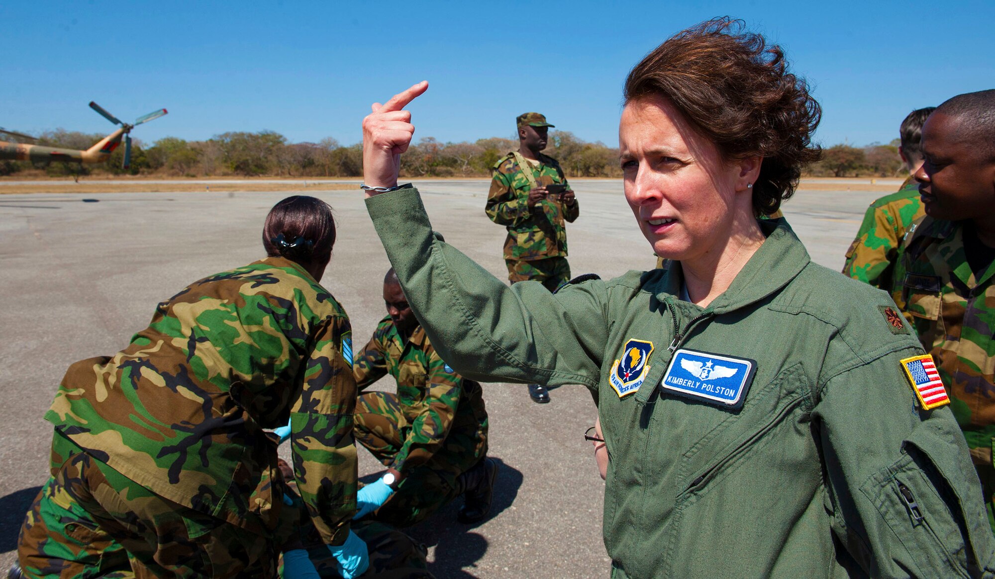 U.S. Air Force Maj. Kimberly Polston, a flight nurse with the United States Air Forces in Europe Surgeon Generals Office, signals a medical team to start an evacuation during an training at Southern Accord 2015 in Lusaka, Zambia. The annual exercise provides U.S. military, United Nations allies and Zambian Defense Forces an opportunity to work and train together as a joint, combined peacekeeping allied force. (U.S. Army Africa photo by U.S. Air Force Staff Sgt. Brian Kimball)