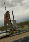 Senior Airman Ian Steck, 91st Missile Maintenance Squadron periodic maintenance team technician, lowers equipment into the launch support building at a launch facility in the missile complex, N.D., Sept. 7, 2016. To prevent safety hazards, PMT Airmen have a two-man process for exchanging equipment up and down ladders. (U.S. Air Force photo/Senior Airman Apryl Hall)