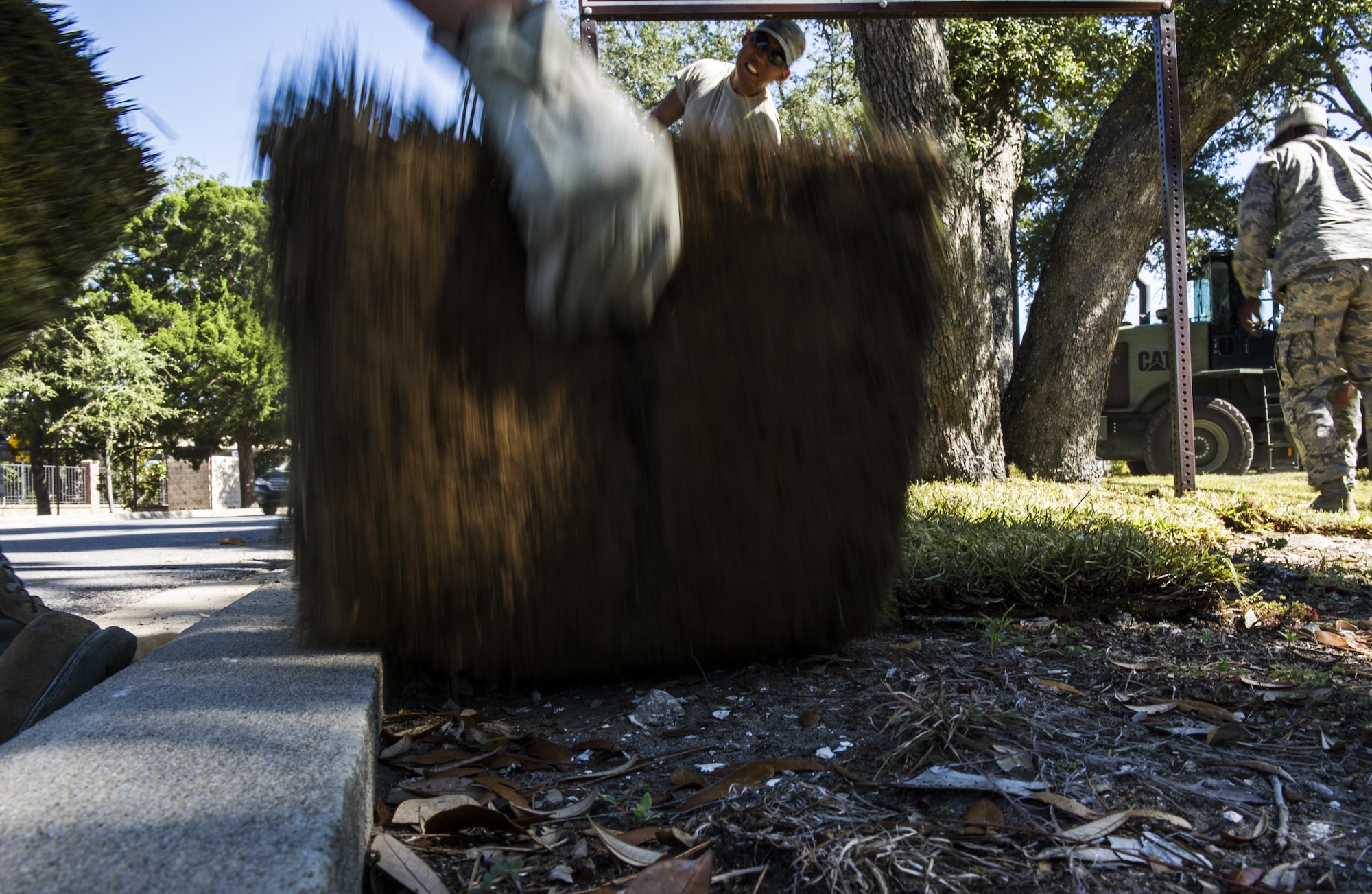 Staff Sgt. Nathan Wilson, a pavement and heavy equipment specialist with the 1st Special Operations Civil Engineer Squadron, lays sod outside the Soundside Club at Hurlburt Field, Fla., Oct. 4, 2016. Sod is used to replace dead grass and is effective in providing increased cooling, improving air and water quality, and assisting in flood prevention by draining water. (U.S. Air Force photo by Airman 1st Class Joseph Pick)