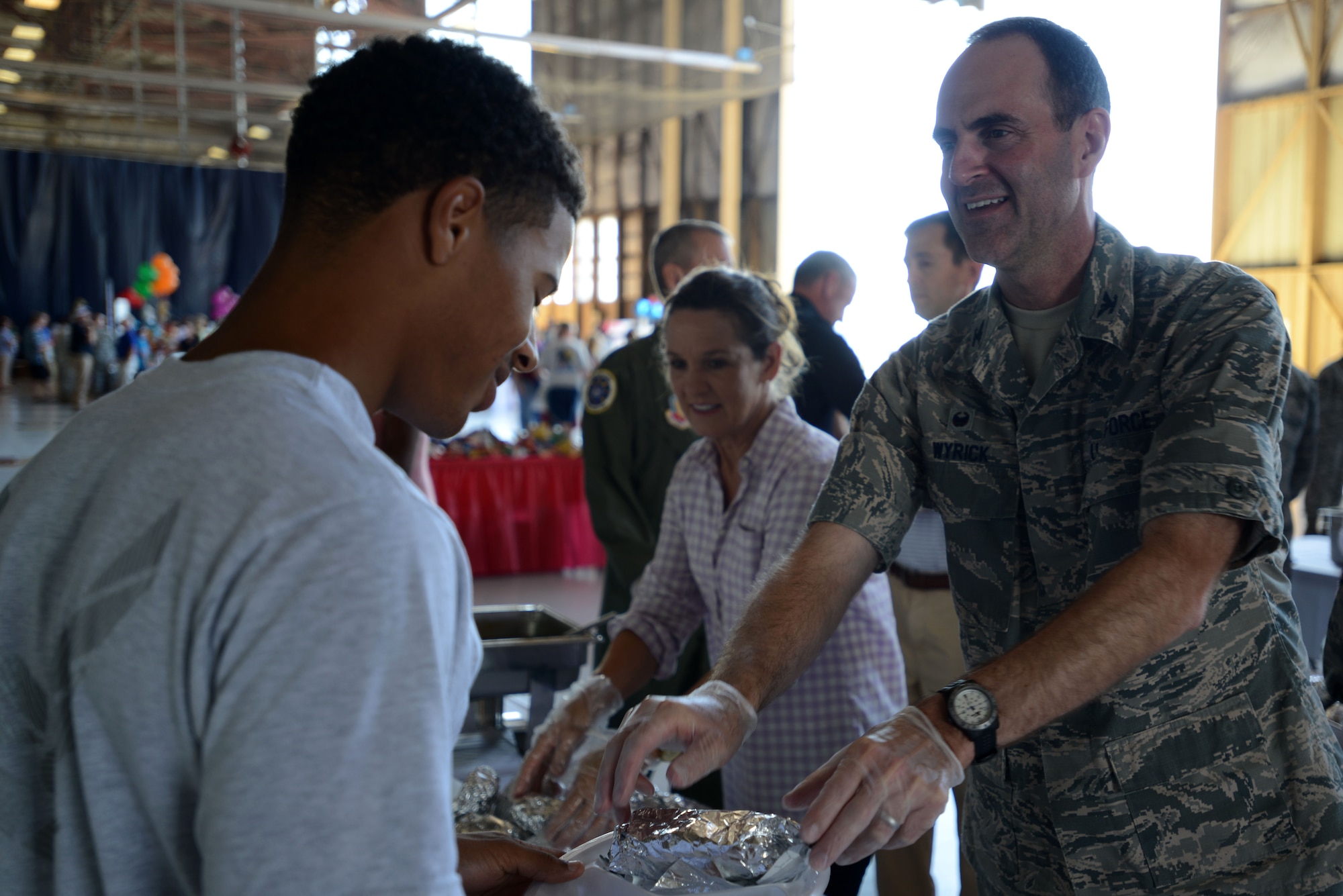U.S. Air Force Col. Brian Wyrick, 20th Medical Group commander, serves food to an Airman during a Military Appreciation Picnic at Shaw Air Force Base, S.C., Sept. 30, 2016. Throughout the picnic, Team Shaw leadership lined up to serve food alongside volunteers from the Sumter community in order to strengthen the bonds of friendship and patriotism. (U.S. Air Force photo by Airman 1st Class Kelsey Tucker)