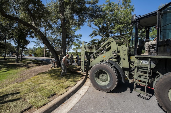 Airmen with the 1st Special Operations Civil Engineer Squadron lay sod at Hurlburt Field, Fla., Oct. 4, 2016. Civil engineer Airmen laid 34 pallets of sod outside the Soundside Club to replace dead grass. (U.S. Air Force photo by Airman 1st Class Joseph Pick)