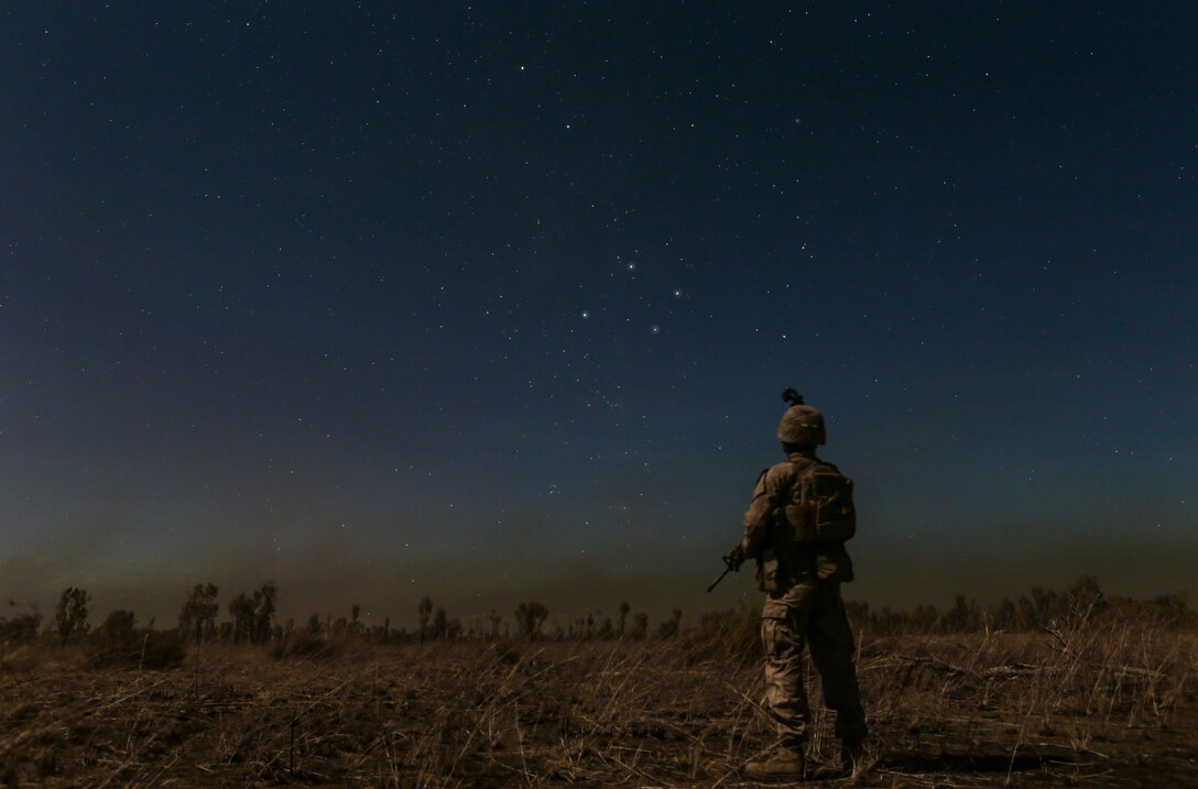 A Marine with Marine Rotational Force – Darwin stands under the Southern Cross star constellation during Exercise Koolendong 16 at Bradshaw Field Training Area, Northern Territory, Australia, Aug. 16, 2016. Koolendong is a trilateral exercise between the Australian Defence Force, U.S. Marine Corps and French Armed Forces New Caledonia. (U.S. Marine Corps photo by Sgt. Sarah Anderson)