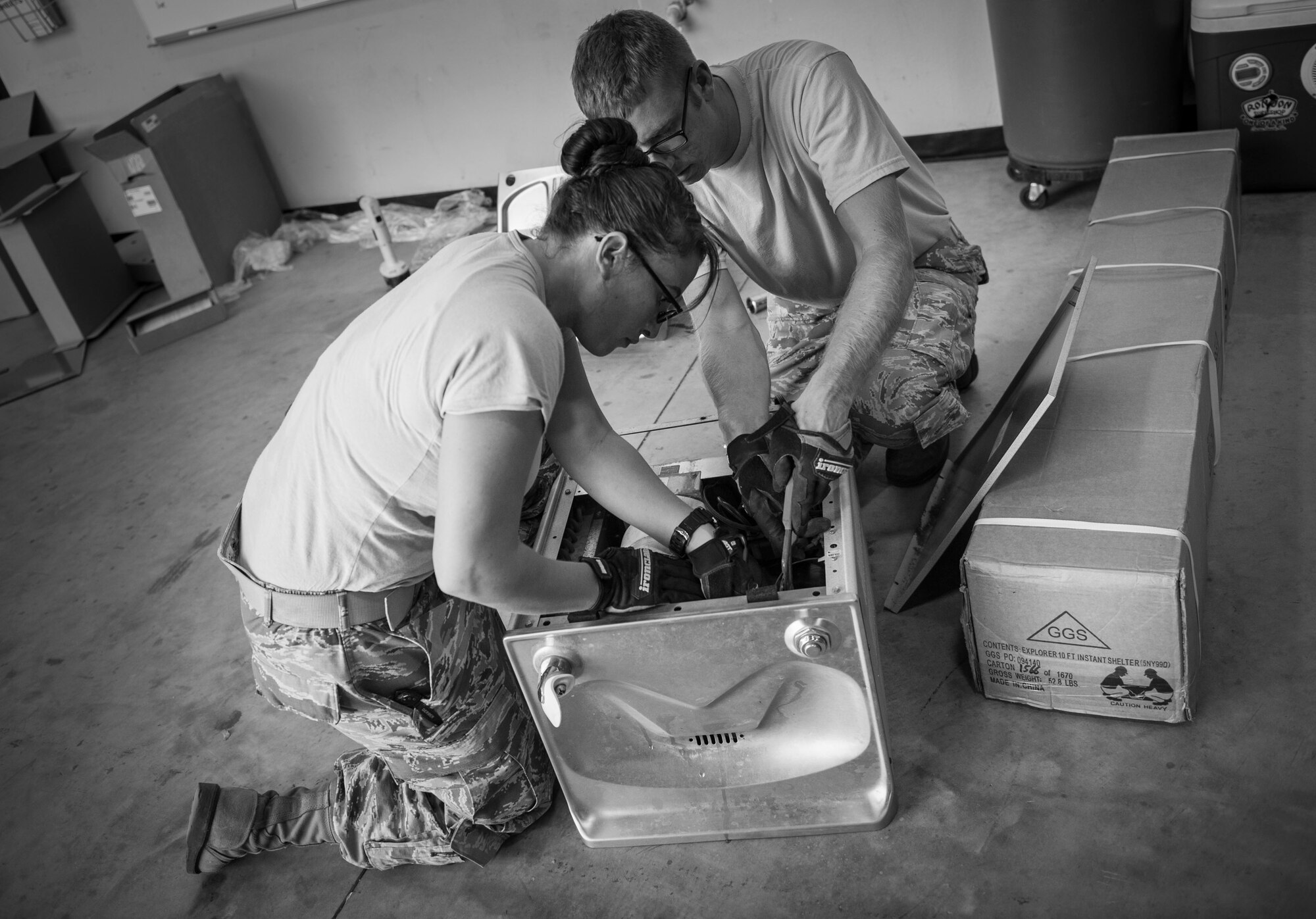 Senior Airman Markita Andrews, left, and Jason Berry, water and fuels systems maintenance journeymen with the 823rd RED HORSE, install a drinking fountain at the RED HORSE compound on Hurlburt Field, Fla., Oct. 3, 2016. Water and fuels systems maintenance Airmen install, inspect, repair and manage plumbing, water distribution, wastewater collection systems and components, fire suppression and backflow prevention systems. (U.S. Air Force photo by Senior Airman Krystal M. Garrett) 