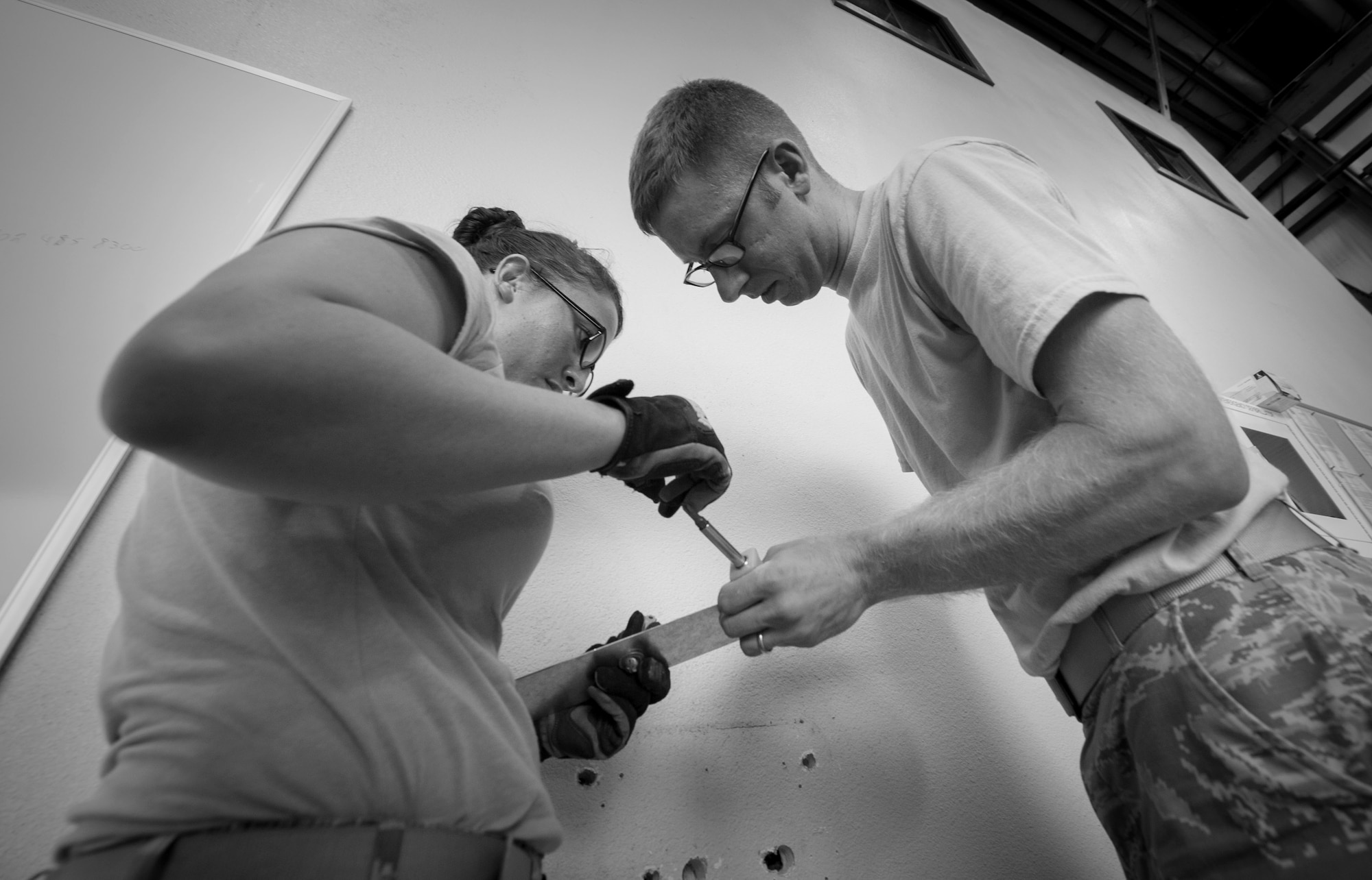 Senior Airman Markita Andrews, left, and Jason Berry, water and fuels systems maintenance journeymen with the 823rd RED HORSE, install a drinking fountain at the RED HORSE compound on Hurlburt Field, Fla., Oct. 3, 2016. Water and fuels systems maintenance Airmen monitor system operations to ensure compliance with local, state, federal and Department of Defense regulations. (U.S. Air Force photo by Senior Airman Krystal M. Garrett)