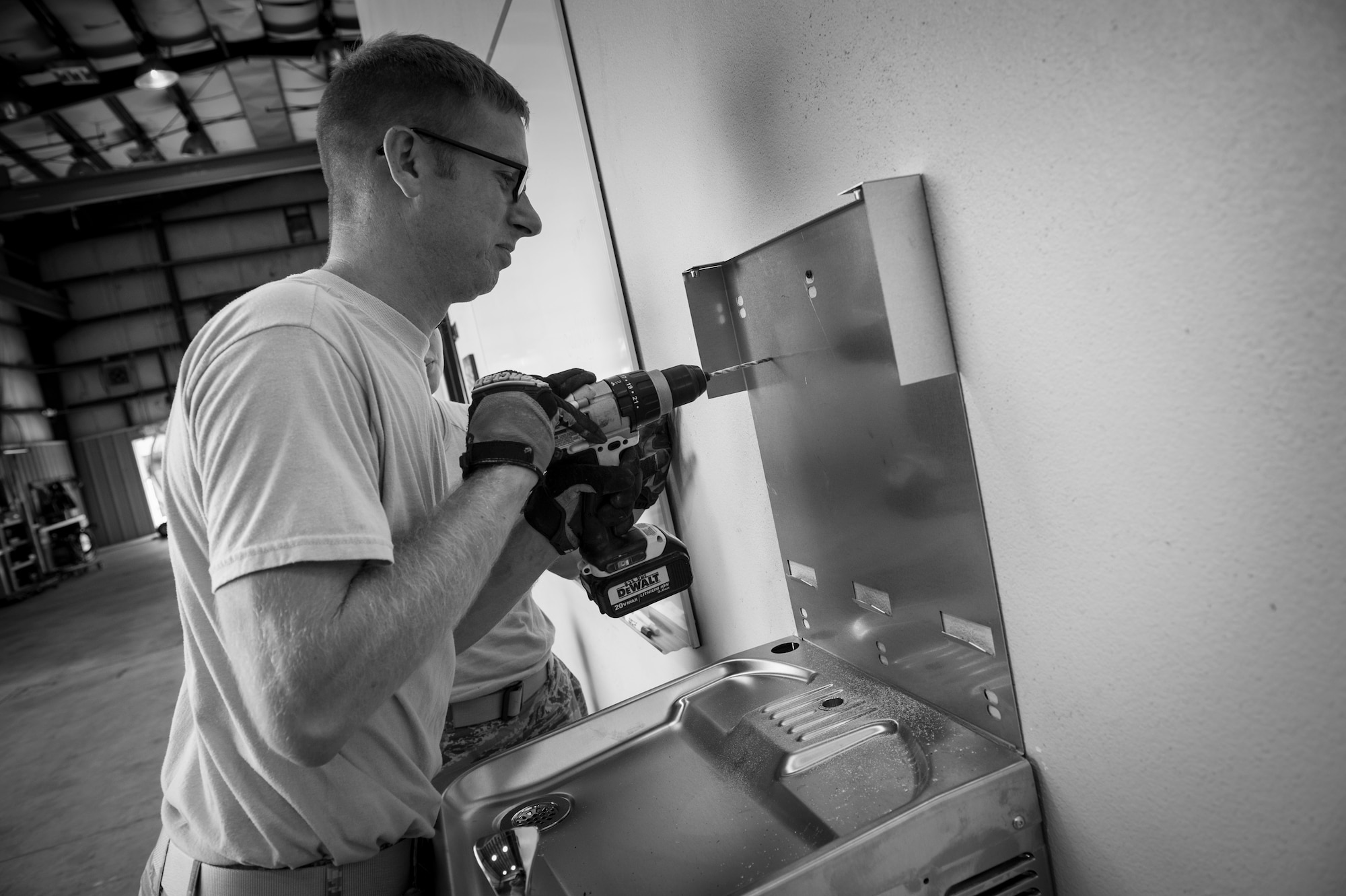 Senior Airman Marikta Andrews, left, and Jason Berry, water and fuels systems maintenance journeyman with the 823rd RED HORSE, install a drinking fountain at the RED HORSE compound on Hurlburt Field, Fla., Oct. 3, 2016. Water and fuels systems maintenance Airmen install, inspect, repair and manage plumbing, water distribution, wastewater collection systems and components, fire suppression and backflow prevention systems. (U.S. Air Force photo by Senior Airman Krystal M. Garrett) 