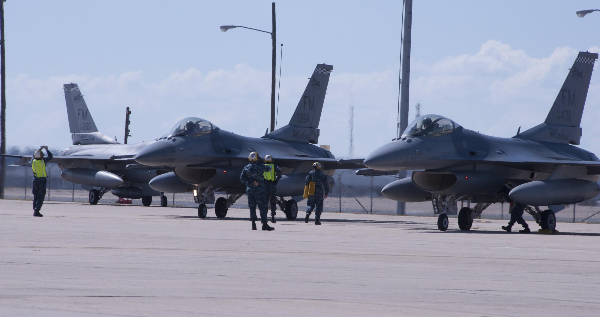 Sailors marshal eight F-16 Fighting Falcons from Homestead Air Reserve Base, Fla., Oct. 5, 2016 at Naval Air Station Fort Worth Joint Reserve Base, Texas. Twelve aircraft relocated here due to Hurricane Matthew's anticipated landfall. The base serves as a safe haven for military aircraft that are in the path of the hurricane. (U.S. Air Force photo by Tech. Sgt. Melissa Harvey)
