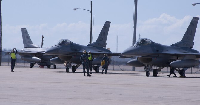 Sailors marshal eight F-16 Fighting Falcons from Homestead Air Reserve Base, Fla., Oct. 5, 2016 at Naval Air Station Fort Worth Joint Reserve Base, Texas. Twelve aircraft relocated here due to Hurricane Matthew's anticipated landfall. The base serves as a safe haven for military aircraft that are in the path of the hurricane. (U.S. Air Force photo by Tech. Sgt. Melissa Harvey)