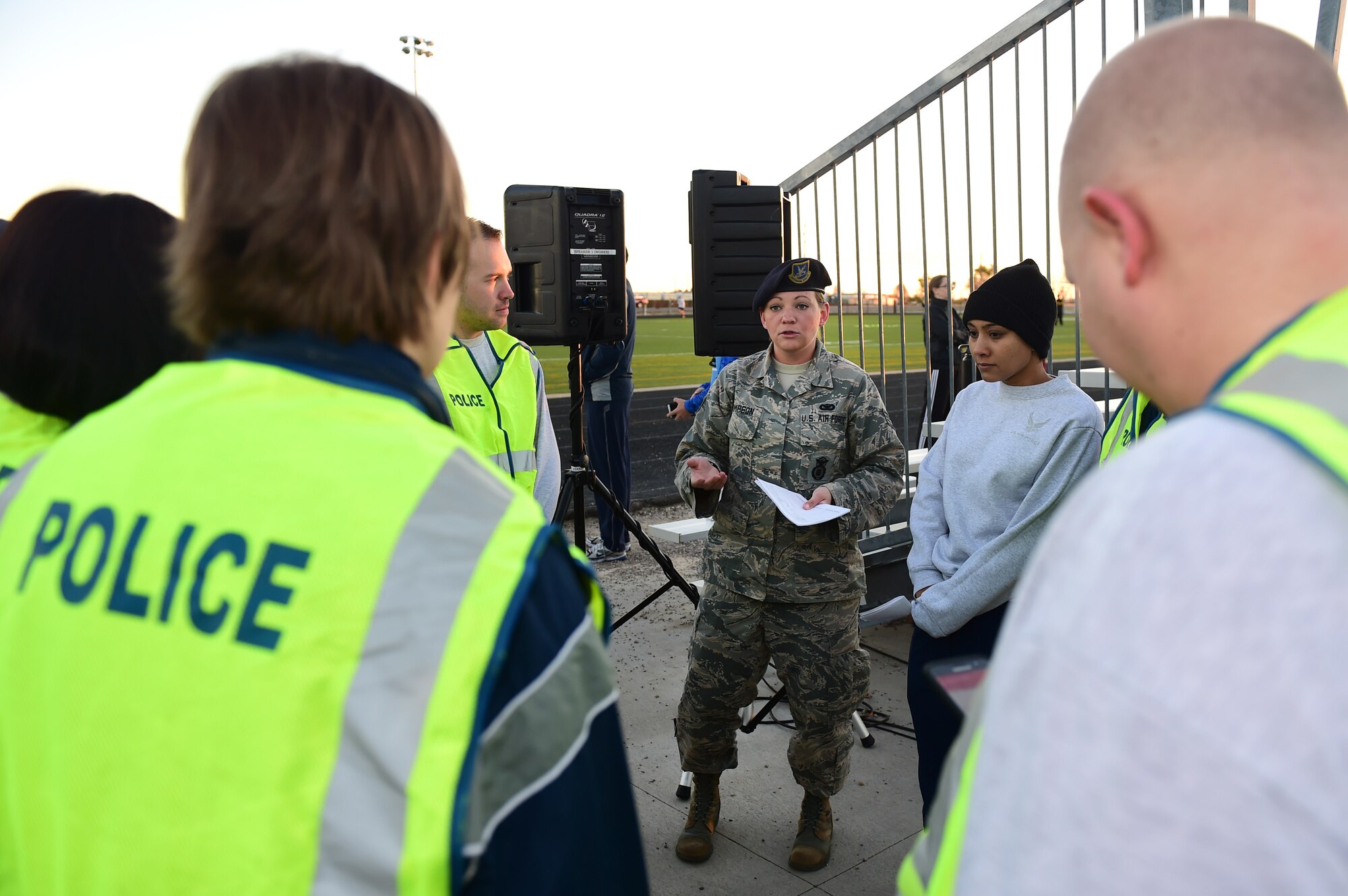 Staff Sgt. Tara Thompson, 460th Security Forces Squadron police services NCO in charge, gives a safety brief to road guards who direct participants during a Domestic Violence Awareness Month 5K Run/Walk Oct. 5, 2016, at the outdoor track on Buckley Air Force Base, Colo. Members of the 460th Medical Group Family Advocacy Program sponsored the event to address the problem of domestic violence in hopes of decreasing the number of people affected. (U.S. Air Force photo by Airman 1st Class Gabrielle Spradling/Released)