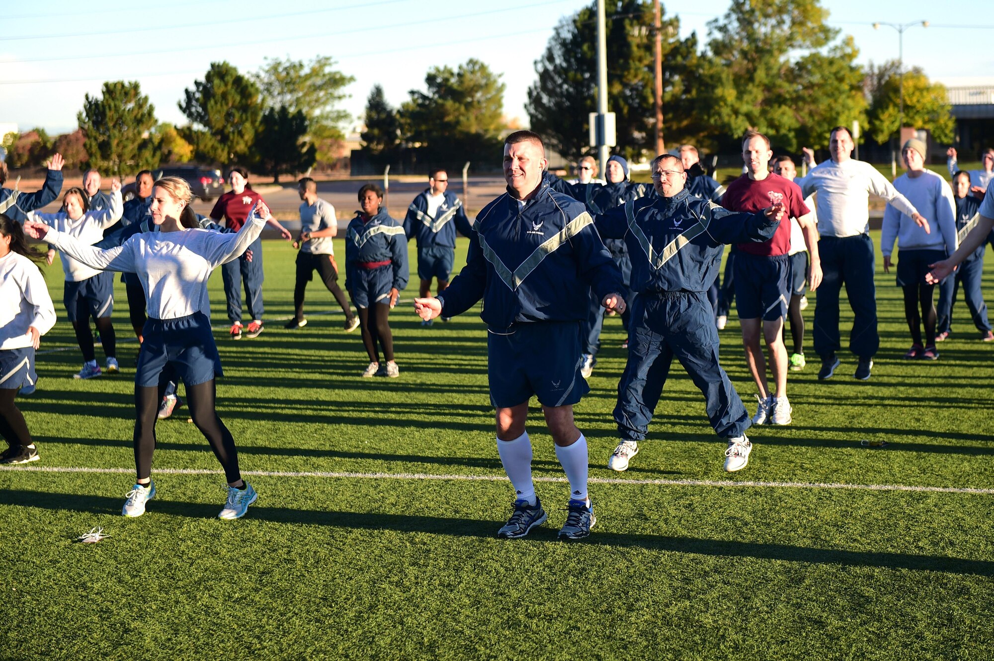 Team Buckley members stretch before participating in a Domestic Violence Awareness Month 5K Run/Walk Oct. 5, 2016, at the outdoor track on Buckley Air Force Base, Colo. The 460th Medical Group Family Advocacy Program hosted the run/walk to kick off National Domestic Violence Awareness Month, which is observed in October. (U.S. Air Force photo by Airman 1st Class Gabrielle Spradling/Released)