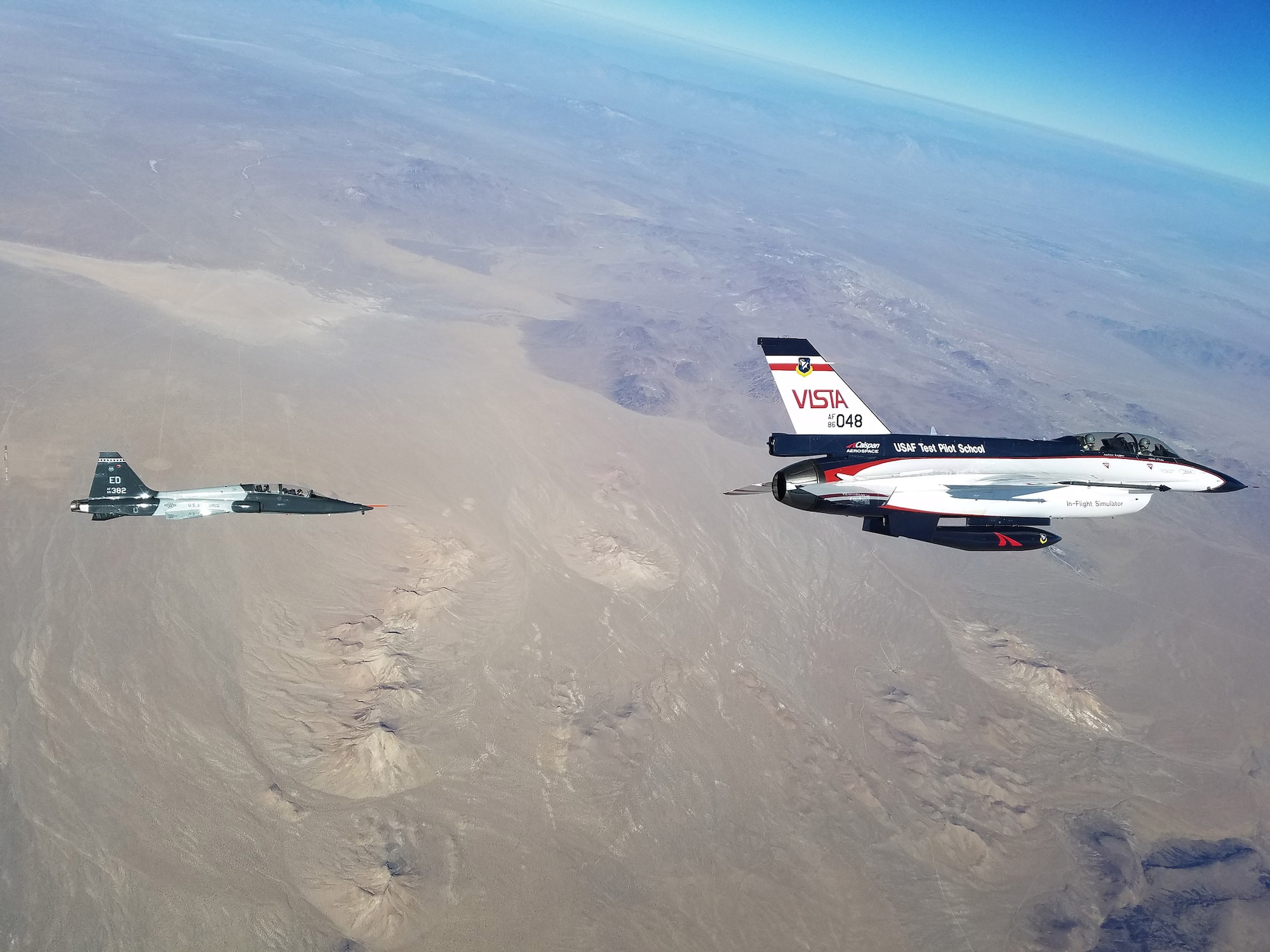 The F-16 VISTA tracks and targets a T-38's during testing of the L1 Adaptive Control System recently. The control system was designed and built by a team from the University of Illinois, Urbana Champaign, and tested by U.S. Air Force Test Pilot School Class 16A as a Test Management Program. (U.S. Air Force Photo by Capt. Craig Porter)
