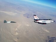 The F-16 VISTA tracks and targets a T-38's during testing of the L1 Adaptive Control System recently. The control system was designed and built by a team from the University of Illinois, Urbana Champaign, and tested by U.S. Air Force Test Pilot School Class 16A as a Test Management Program. (U.S. Air Force Photo by Capt. Craig Porter)