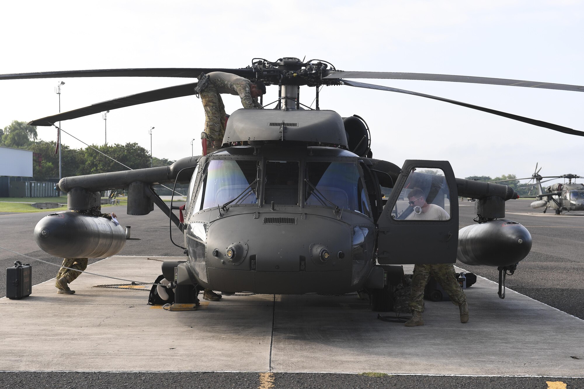 The crew of a UH-60 Blackhawk assigned to Joint Task Force-Bravo’s 1st Battalion, 228th Aviation Regiment, prepare their aircraft for flight at Soto Cano Air Base, Honduras, Oct. 5, 2016. U.S. Southern Command directed a team of approximately 100 military personnel and nine helicopters to be staged and ready to support U.S. disaster relief operations in Haiti in the aftermath of Hurricane Matthew. (U.S. Air Force photo by Staff Sgt. Siuta B. Ika)