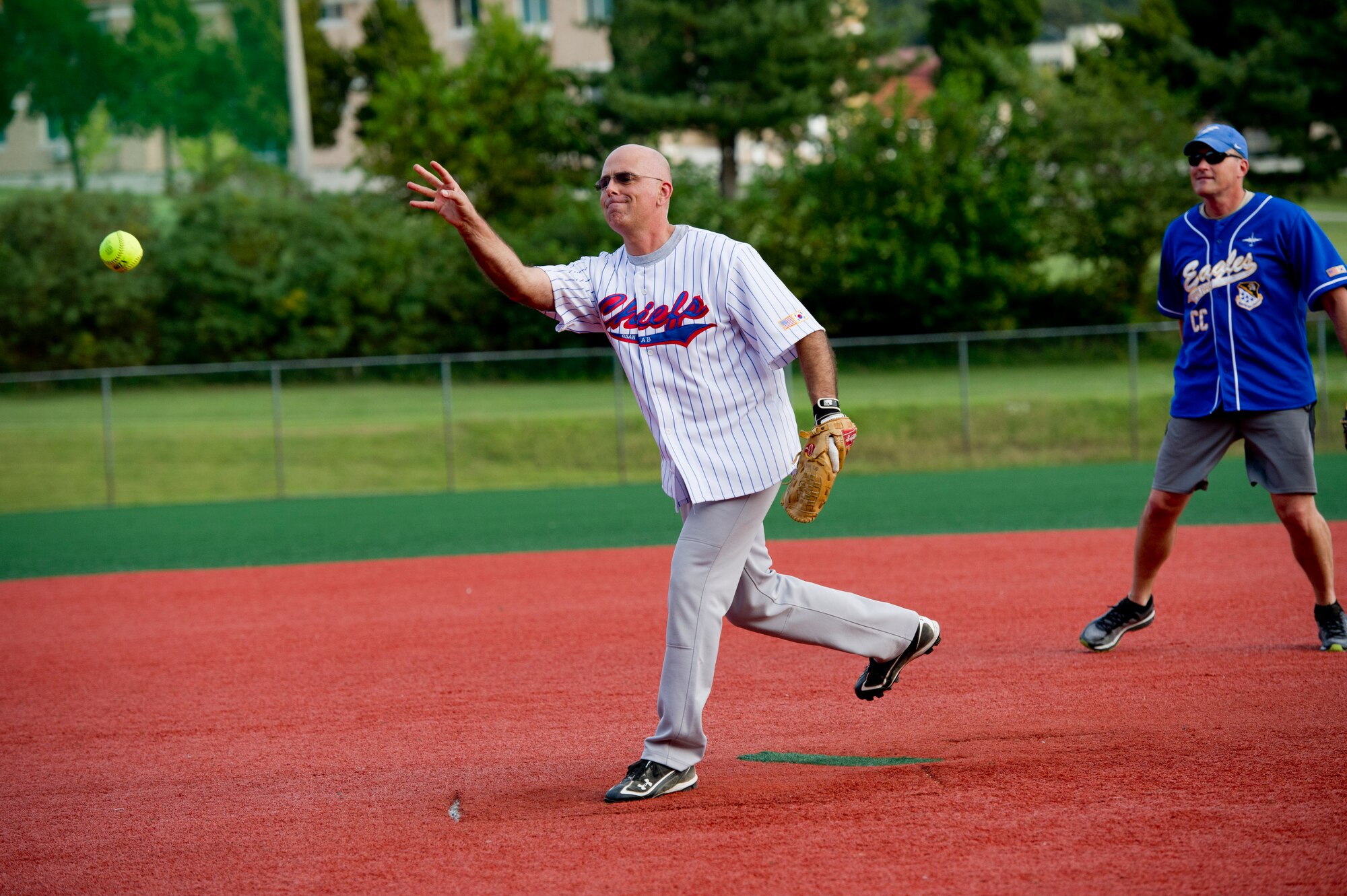 U.S. Air Force Chief Master Sgt. Alexander Del Valle, 51st Fighter Wing command chief, throws a pitch during the Eagles vs. Chiefs softball game at Osan Air Base, Republic of Korea, Sept. 29, 2016. The Eagles vs. Chiefs softball game was the first event of Osan Cup 2016, a two-day sporting event to build teamwork, resiliency, camaraderie and family. (U.S. Air Force photo by Staff Sgt. Jonathan Steffen)