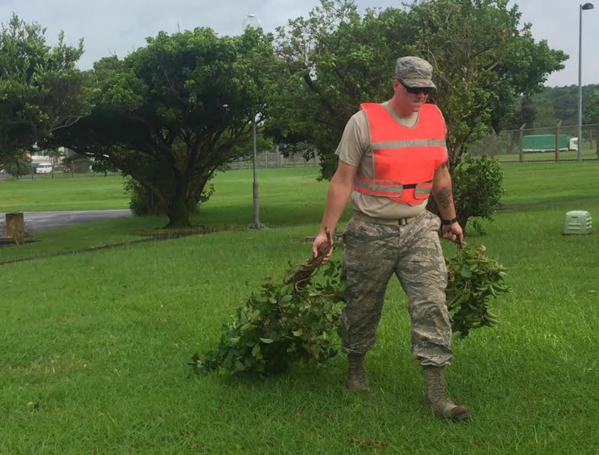 U.S. Air Force Staff Sgt. Collin Tompkins, a pavement maintenance and heavy equipment operator with the 18th Civil Engineer Squadron, removes tree branches that were blown from a tree during Typhoon Chaba, Oct. 5, 2016, at Kadena Air Base, Japan. Members of the 18th Civil Engineer Squadron on Kadena took part in preparation activities prior to Chaba, making sure base residents were prepared for the storm. (U.S. Air Force photo by Airman 1st Class Corey Pettis) 