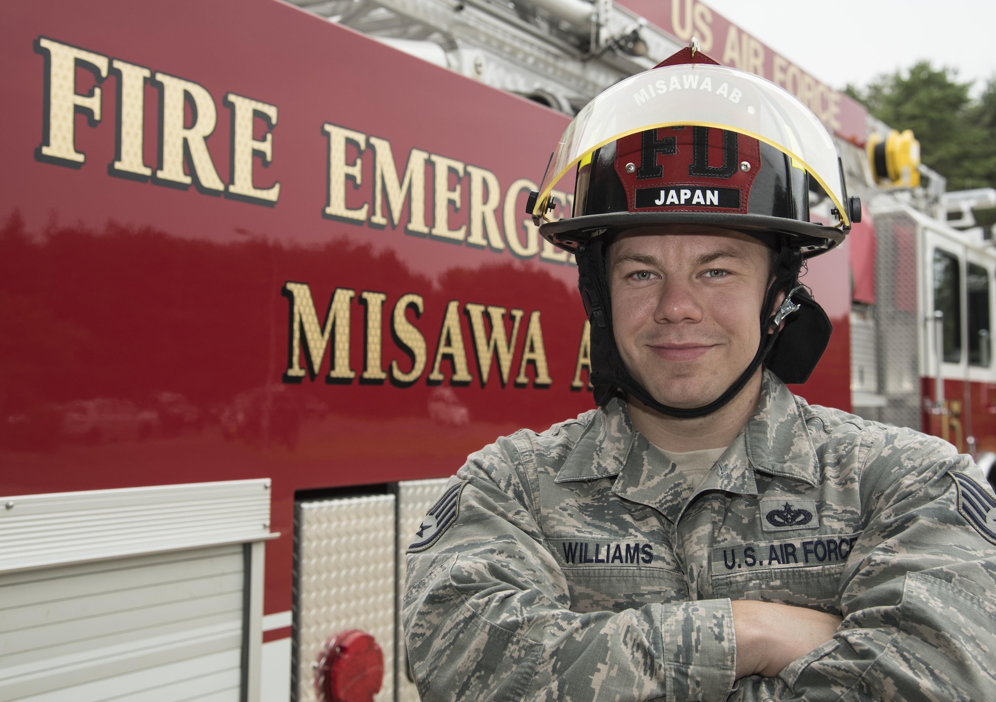 U.S. Air Force Staff Sgt. Cody Williams, the logistics NCO in charge with the 35th Civil Engineer Squadron, poses in front of a firetruck at Misawa Air Base, Japan, Sept. 27, 2016. Williams is a native of Ocala, Florida, home to the Florida State Fire College. Williams said, like many from his home town, he knew he always wanted to be a firefighter. (U.S. Air Force photo by Airman 1st Class Sadie Colbert)