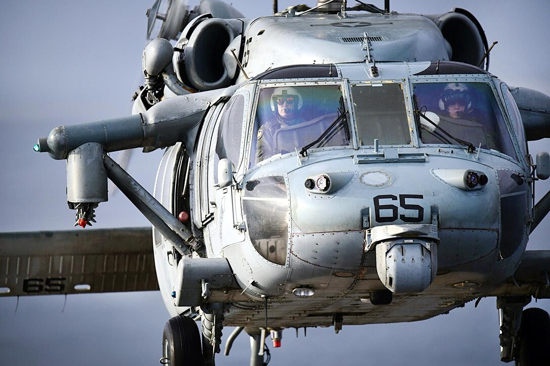 A Navy MH-60S Seahawk helicopter conducts a vertical replenishment of the amphibious assault ship USS Bataan in the Atlantic Ocean, Oct. 1, 2016. Navy photo by Petty Officer 1st Class Julie R. Matyascik