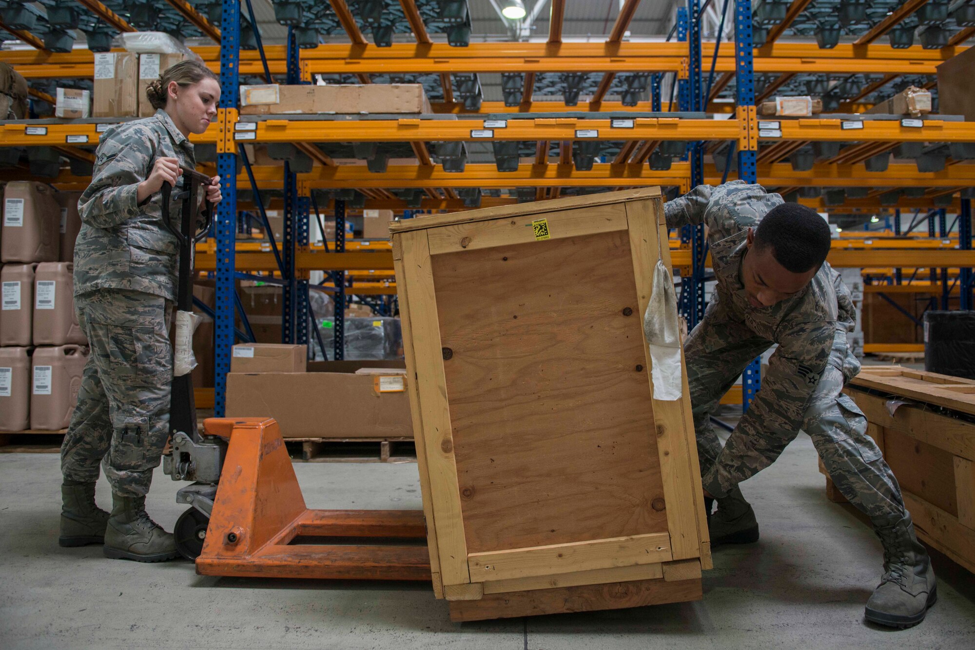 U.S. Air Force Airman Kennedy Trolinder (left), 39th Logistics Readiness Squadron (LRS) central storage apprentice, and Senior Airman Turon Boyd, 39th LRS service center journeyman, load cargo onto a pallet jack in the supply warehouse Oct. 4, 2016, at Incirlik Air Base, Turkey. The warehouse contains a broad spectrum of items to support base units and agencies. (U.S. Air Force photo by Senior Airman John Nieves Camacho)