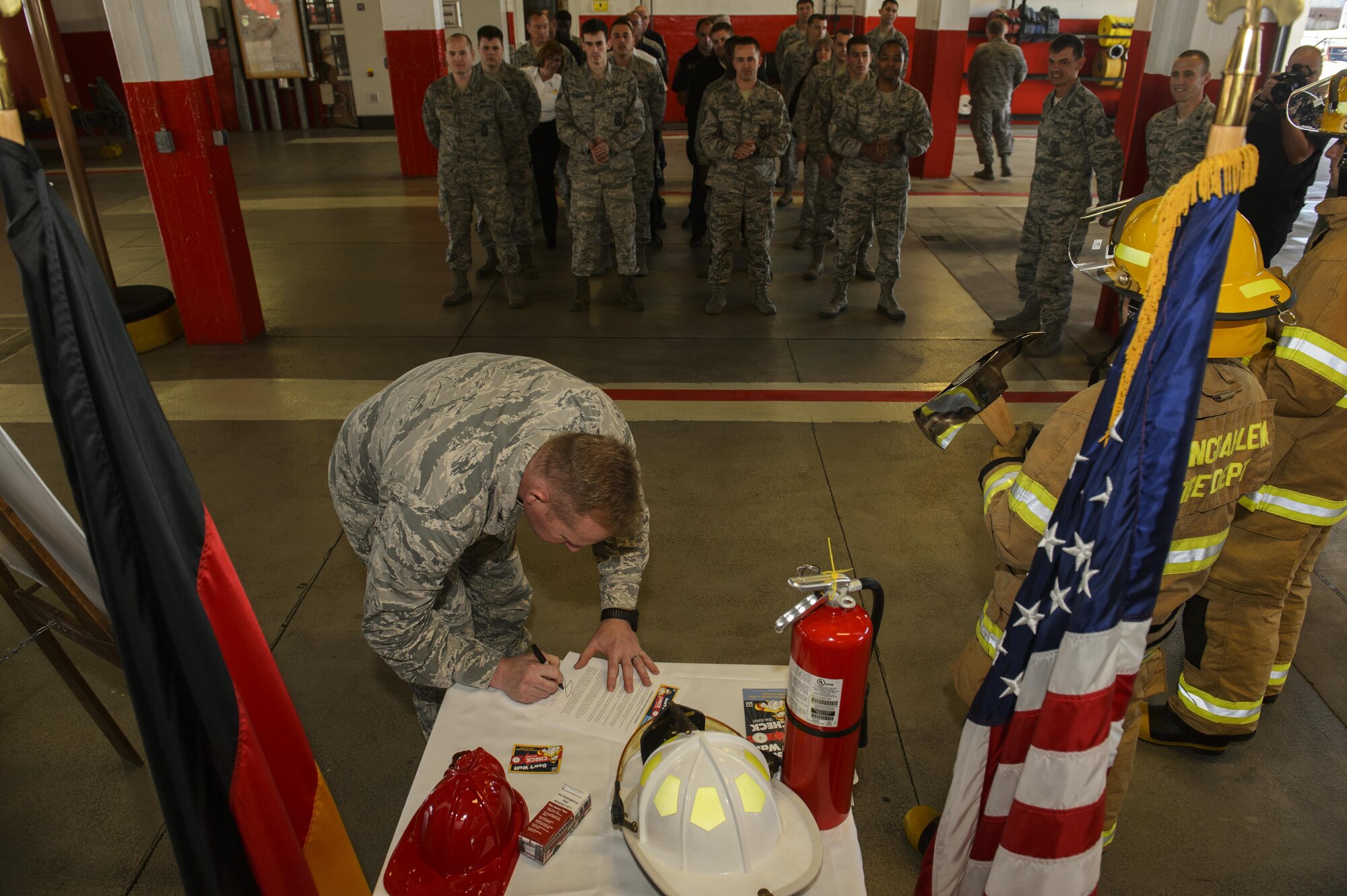 U.S. Air Force Col. Joseph McFall, 52nd Fighter Wing commander, signs the 2016 Fire Prevention Week proclamation at the base fire department on Spangdahlem Air Base, Germany, Oct. 5, 2016. This years Fire Prevention Week will be observed Oct. 9-15 with the theme "Don't wait - Check the Date." The emphasis is on replacing batteries yearly in all smoke alarms and replacing the alarms themselves every 10 years. (U.S. Air Force photo by Staff Sgt. Jonathan Snyder)