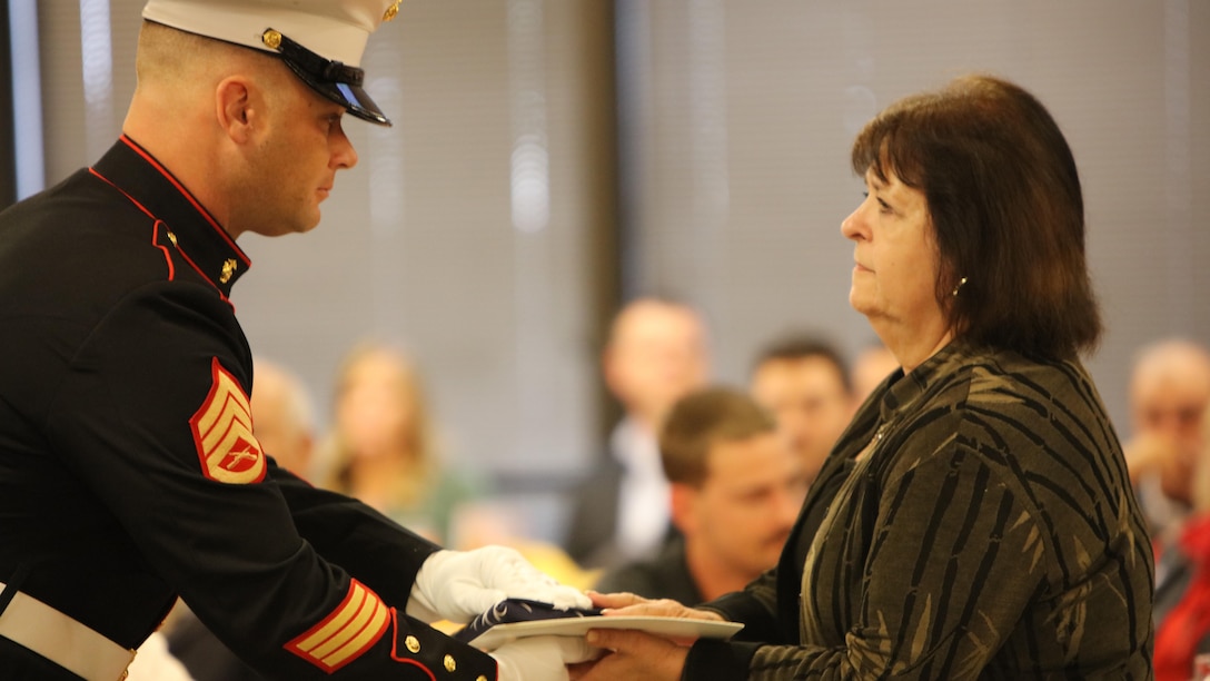 Staff Sgt. Christian Wolanski, a recruiter at Recruiting Station St. Louis, delivers a flag to a Gold Star mother at the 7th Annual Gold Star Family Luncheon on Oct. 1, 2016 in St. Louis, Mo. The term "Gold Star" refers to a family who lost a loved one in war.