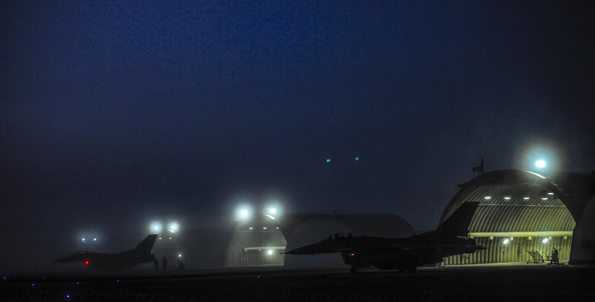 U.S. Air Force F-16 Fighting Falcons from the 8th Fighter Wing are parked outside of their hanger bays during Beverly Pack 17-1 at Kunsan Air Base, Republic of Korea, Oct. 4, 2016. The U.S. Air Force and Republic of Korea Air Force provide combat capabilities and training by performing exercises throughout the year to enhance communication and interoperability between military forces so they are prepared to fight as a combined force. (U.S. Air Force photo by Senior Airman Colville McFee/Released)