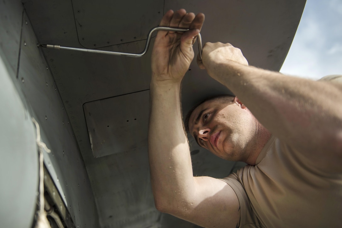 Air Force Staff Sgt. Michael Dukes removes rivets from a panel on an F-16C Fighting Falcon aircraft at Bagram Airfield, Afghanistan, Oct. 5, 2016. Dukes is an electrical and environmental systems specialist assigned to the 455th Expeditionary Aircraft Maintenance Squadron. Air Force photo by Senior Airman Justyn M. Freeman