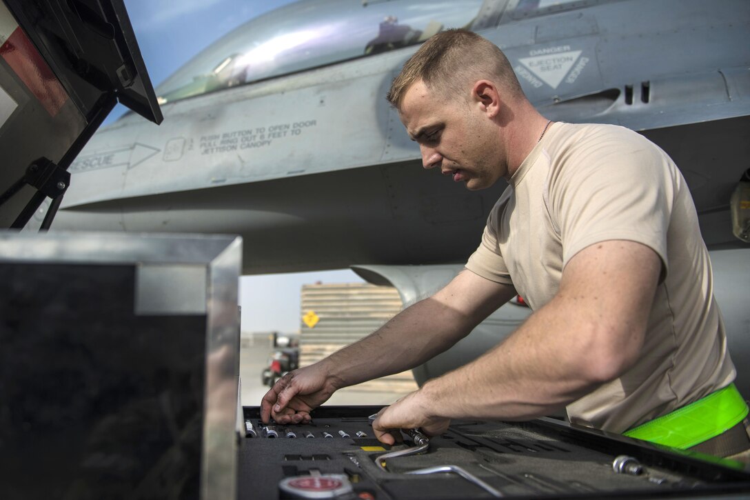 Air Force Staff Sgt. Michael Dukes prepares tools to repair a heat exchanger on an F-16C Fighting Falcon aircraft at Bagram Airfield, Afghanistan, Oct. 5, 2016. Dukes is an electrical and environmental systems specialist assigned to the 455th Expeditionary Aircraft Maintenance Squadron. Air Force photo by Senior Airman Justyn M. Freeman