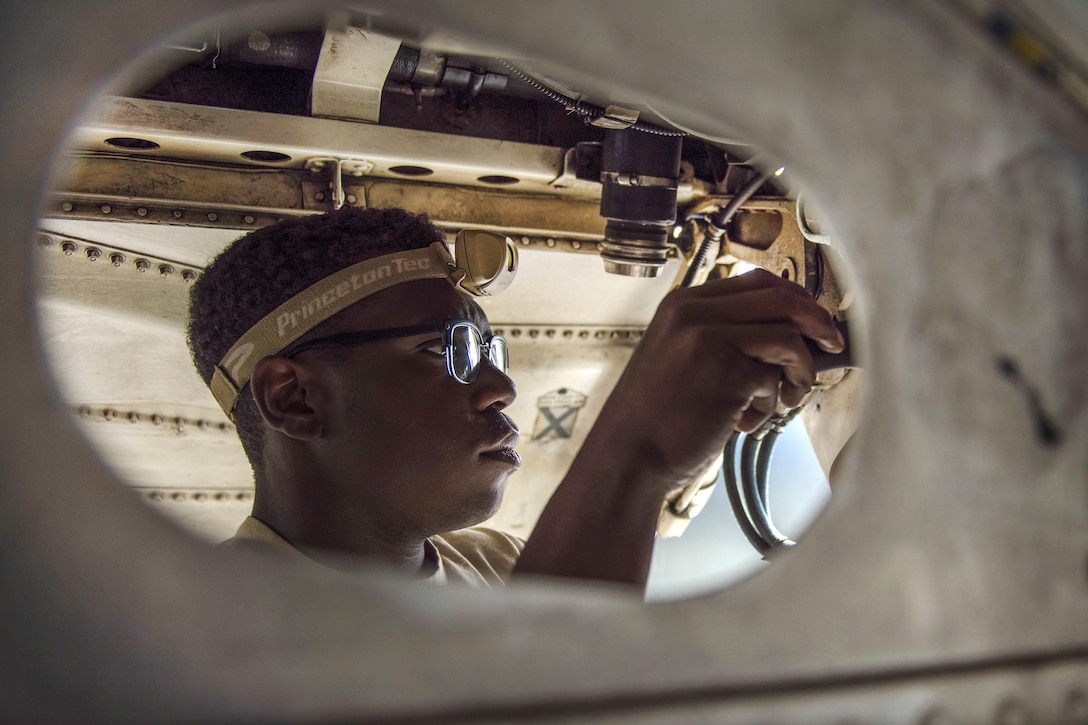 Air Force Airman 1st Class Keion Newman replaces a heat exchanger on an F-16C Fighting Falcon aircraft at Bagram Airfield, Afghanistan, Oct. 5, 2016. Newman is an electrical and environmental systems specialist assigned to the 455th Expeditionary Aircraft Maintenance Squadron. Air Force photo by Senior Airman Justyn M. Freeman