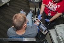 Tech. Sgt. Jonah Uhl, 5th Civil Engineer Squadron station chief, has blood drawn at the Battle of the Badges blood drive at Minot Air Force Base, N.D., Sept. 30, 2016. The Battle of the Badges is a friendly contest between the base fire department and security forces squadrons in an effort to donate the largest amount of blood. (U.S. Air Force photo/Airman 1st Class Christian Sullivan)