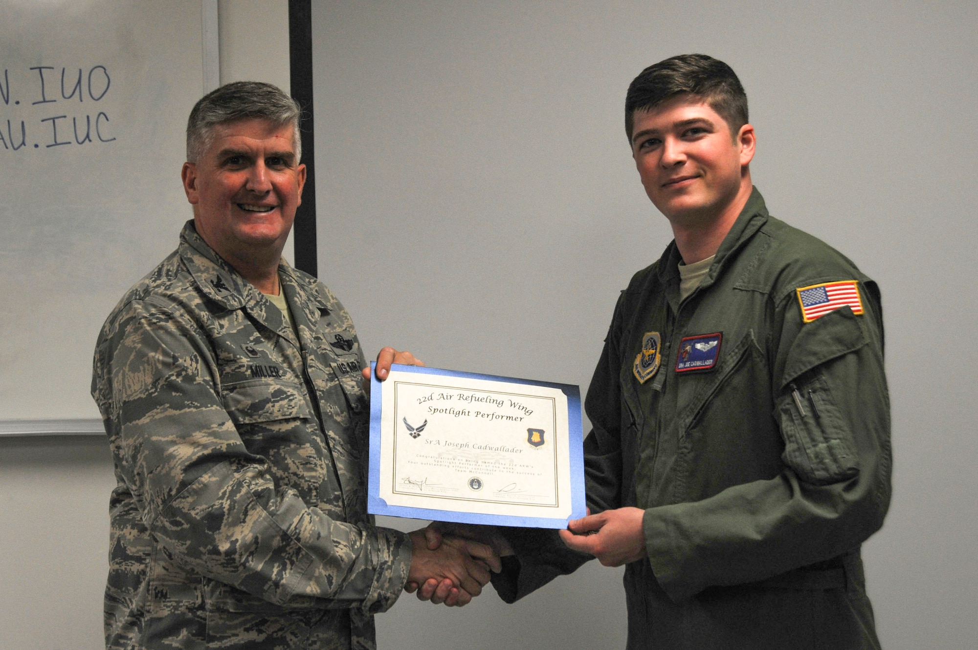 Senior Airman Joseph Cadwallader, 349th Air Refueling Squadron boom operator, poses with Col. Albert Miller, 22nd Air Refueling Wing commander, Oct. 4, 2016, at McConnell Air Force Base, Kan. Cadwallader received the spotlight performer for the week of Sept. 12-16. (U.S. Air Force photo/Airman 1st Class Jenna K. Caldwell)