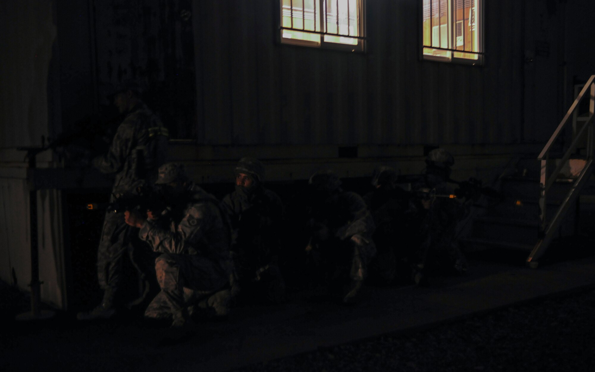 U.S. Air Force 8th Security Forces Squadron, Alpha Sector mid-shift members, execute security maneuvers outside of a building during exercise Beverly Pack 17-1 at Kunsan Air Base, Republic of Korea, Oct. 6, 2016. The U.S. Air Force and Republic of Korea Air Force provide combat capabilities and training by performing exercises throughout the year to enhance communication and interoperability between military forces so they are prepared to fight as a combined force. (U.S. Air Force photo by Senior Airman Colville McFee/Released) 