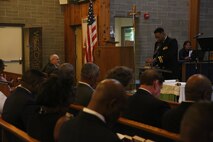 Lt. Cmdr. Raynard Allen, base command chaplain for Marine Corps Air Station New River, says a prayer for Gunnery Sgt. Glen J. White at New River, Sept. 25. The congregation of McCutcheon Memorial Chapel honor Gunnery Sgt. Glen J. White with a plaque for his 27 years of active duty service to his country and over 40 years to the chapel. (U.S. Marine Corps photo by Pfc. Juan Madrigal/Released)