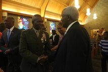 Lt. Gen. Ronald L. Bailey, deputy commandant of Class Policy at Headquarters Marine Corps, shakes hands with a member of the chapel at Marine Corps Air Station New River, Sept. 25. The congregation of McCutcheon Memorial Chapel honor Gunnery Sgt. Glen J. White with a plaque for his 27 years of active duty service to his country and over 40 years to the chapel. (U.S. Marine Corps photo by Pfc. Juan Madrigal/Released)