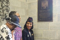 Gina Francis, daughter of Gunnery Sgt. Glen J. White, admires the plaque made in honor of her father with her sister and aunt at Marine Corps Air Station New River, Sept. 25. The congregation of McCutcheon Memorial Chapel honor Gunnery Sgt. Glen J. White with a plaque for his 27 years of active duty service to his country and over 40 to the chapel. (U.S. Marine Corps photo by Pfc. Juan Madrigal/Released)
