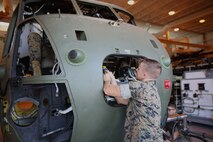 Lance Cpl. Jeffrey McCarn connects cables to the front of a CH-53 helicopter at the Center for Naval Aviation Technical Training on Marine Corps Air Station New River, Oct. 3. CNATT trains Marines and Sailors in operational maintenance and repair of aeronautical equipment at the air station. McCarn is a student at CNATT. (U.S. Marine Corps photo by Pfc. Juan Madrigal/Released)