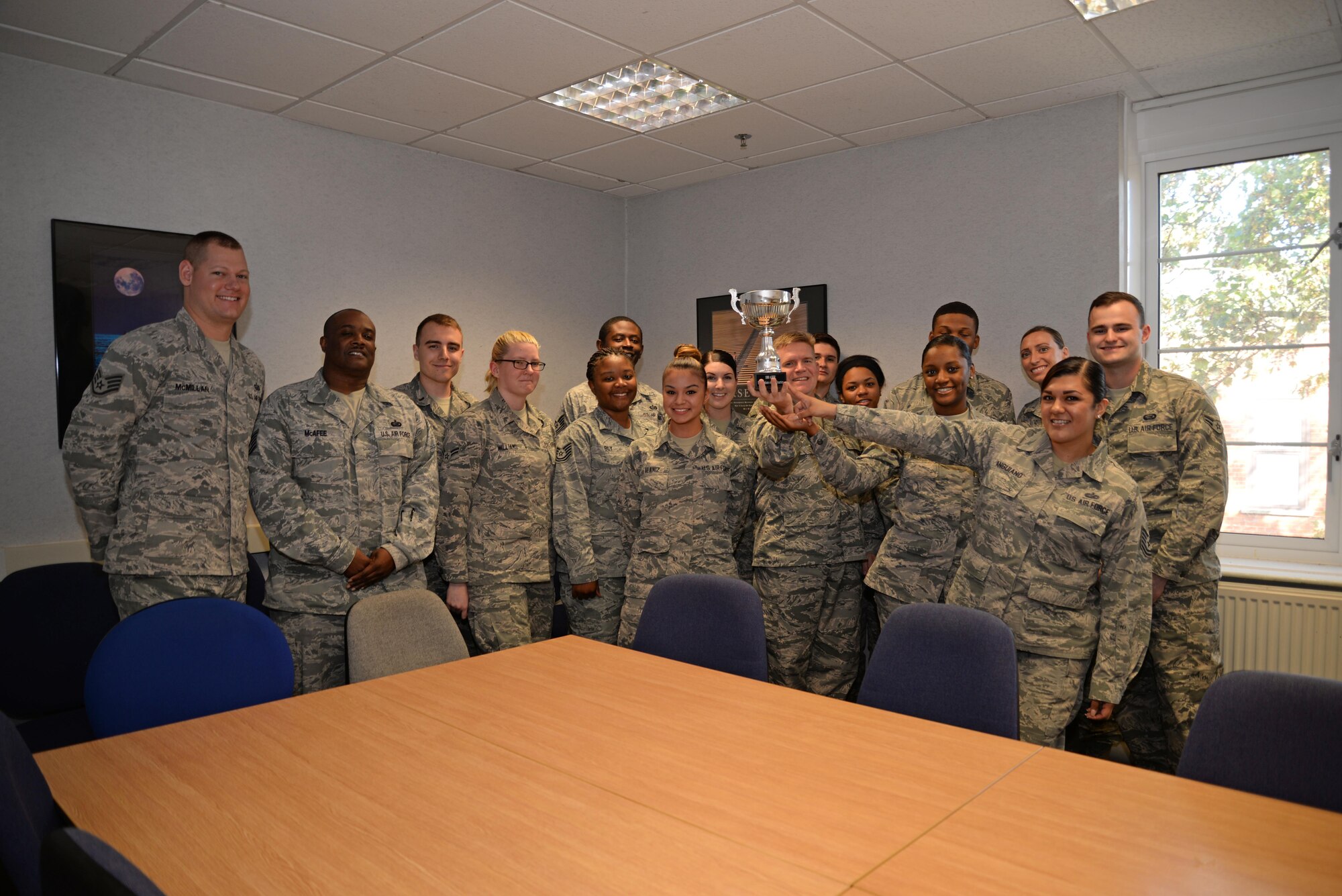 U.S. Air Force Airmen from the 100th Force Support Squadron Manpower and Organization office, pose for a photograph with their Innovation of the Quarter award, Oct. 4, 2016, on RAF Mildenhall, England. U.S. Air Force Tech. Sgt. Laura Anguiano, second from right, 100th FSS Manpower and Organization section chief, led the team to review more than 2,000 enlisted performance reports in fewer than six days. This process normally takes up to 30 days, but her innovative rapid improvement event slashed the processing time and saved 45 man-hours per month in the review process. (U.S. Air Force photo by Senior Airman Christine Halan)