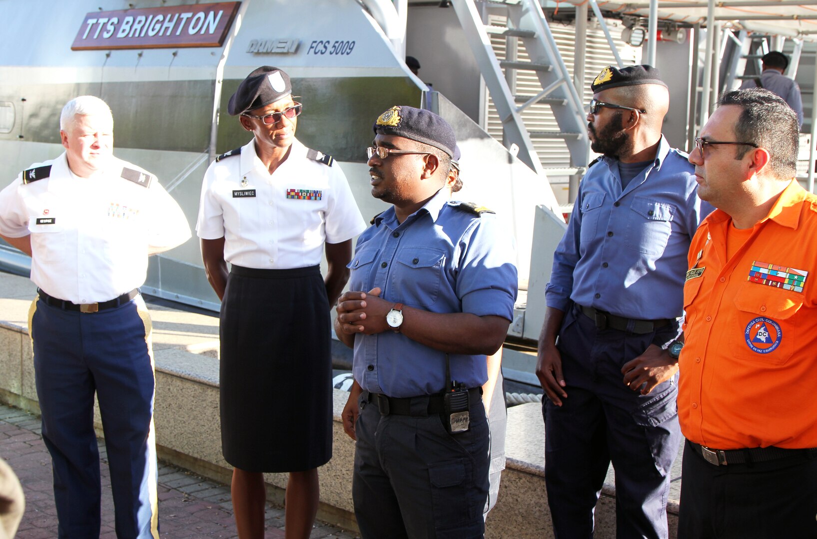 Sub. Lt. Julio Vance (center), Trinidad and Tobago Defense Force Coast Guard executive officer, guides a tour on the TTS Brighton, a vessel used in the assistance of disasters. The visitors were participants of a humanitarian assistance/disaster relief workshop held in Port of Spain, Trinidad, Sept. 12-15. 