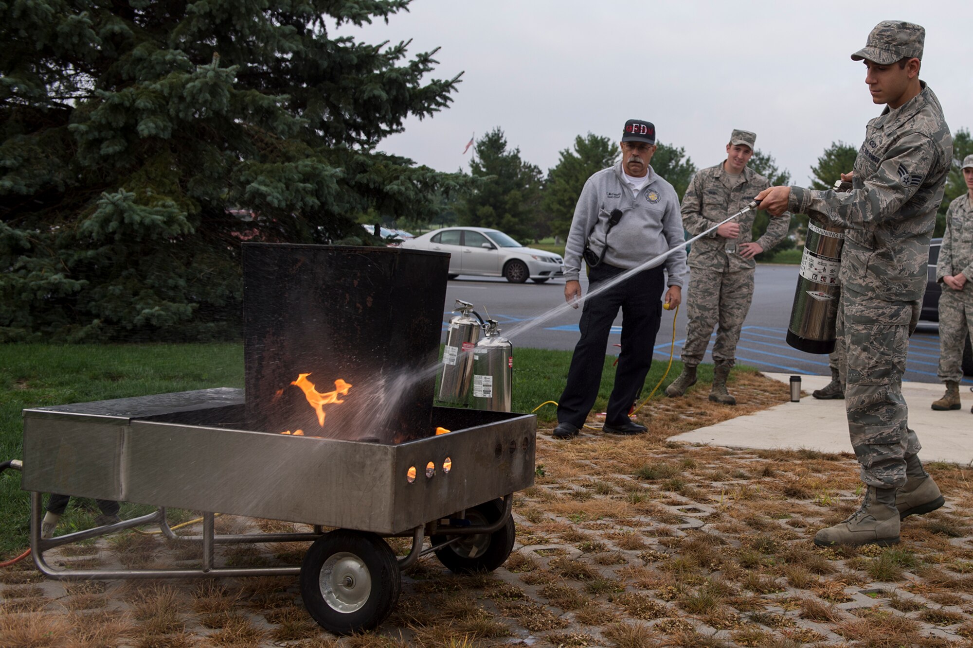 Senior Airman Dominic Zaffino, 434th Air Refueling Wing command post controller, puts out a fire during a hands-on fire extinguisher training October 2, 2016 at Grissom Air Reserve Base, Ind. The training allows command post staff to gain experience in the proper use of fire extinguishers. (U.S. Air Force photo/Staff Sgt. Dakota Bergl)