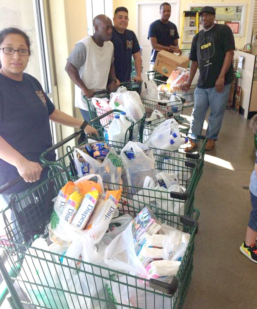 Sailors from the Navy Medicine Training Support Center, or NMTSC, at Joint Base San Antonio-Fort Sam Houston, leave a store with several baskets full of supplies to be delivered to Lafayette, La., as part of a donation drive to help victims of the Louisiana flood Sept. 24.