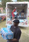 Sailors from the Navy Medicine Training Support Center, or NMTSC, at JBSA-Fort Sam Houston, unload bottled water at a church in Lafayette, La., as part of a donation drive to help victims of the Louisiana flood Sept. 24. Overall, 3,840 bottles of water and more than 150 pounds of non-perishable food items, clothing and cleaning supplies were gathered and donated to the area. 