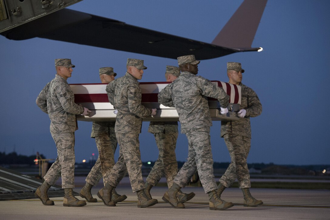 An Air Force team carries the remains of Maj. Troy Gilbert from an aircraft at Dover Air Force Base, Del., Oct. 3, 2016. Gilbert was killed Nov. 27, 2006, when his F-16C Fighting Falcon crashed 20 miles northwest of Baghdad. U.S. forces were able to return the F-16 pilot’s remains approximately 10 years after he was killed in combat operations saving the lives of U.S. service members and coalition allies. Air Force Photo by Senior Airman Aaron J. Jenne