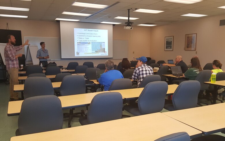 Under the authority of the Great Lakes Tributary Modeling program, the Corps of Engineers, Buffalo District is poised to assist state and local resource agencies in evaluating their watershed planning needs and alternatives for soil conservation and non-point source pollution prevention. USACE employees Michael Voorhees and Michael Snyder stand in front of a class at Ft. Drum in August 2016 conducting a web-based tools training.