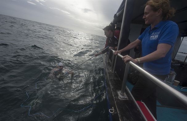 Maj. Casey Bowen (left), a 2004 graduate of the U.S. Air Force Academy, stops for a drink, Sept. 26, 2016 as he swims the English Channel. Bowen swam from Dover, England, to the French coast. (DOD News photo/Tech. Sgt. Brian Kimball)
