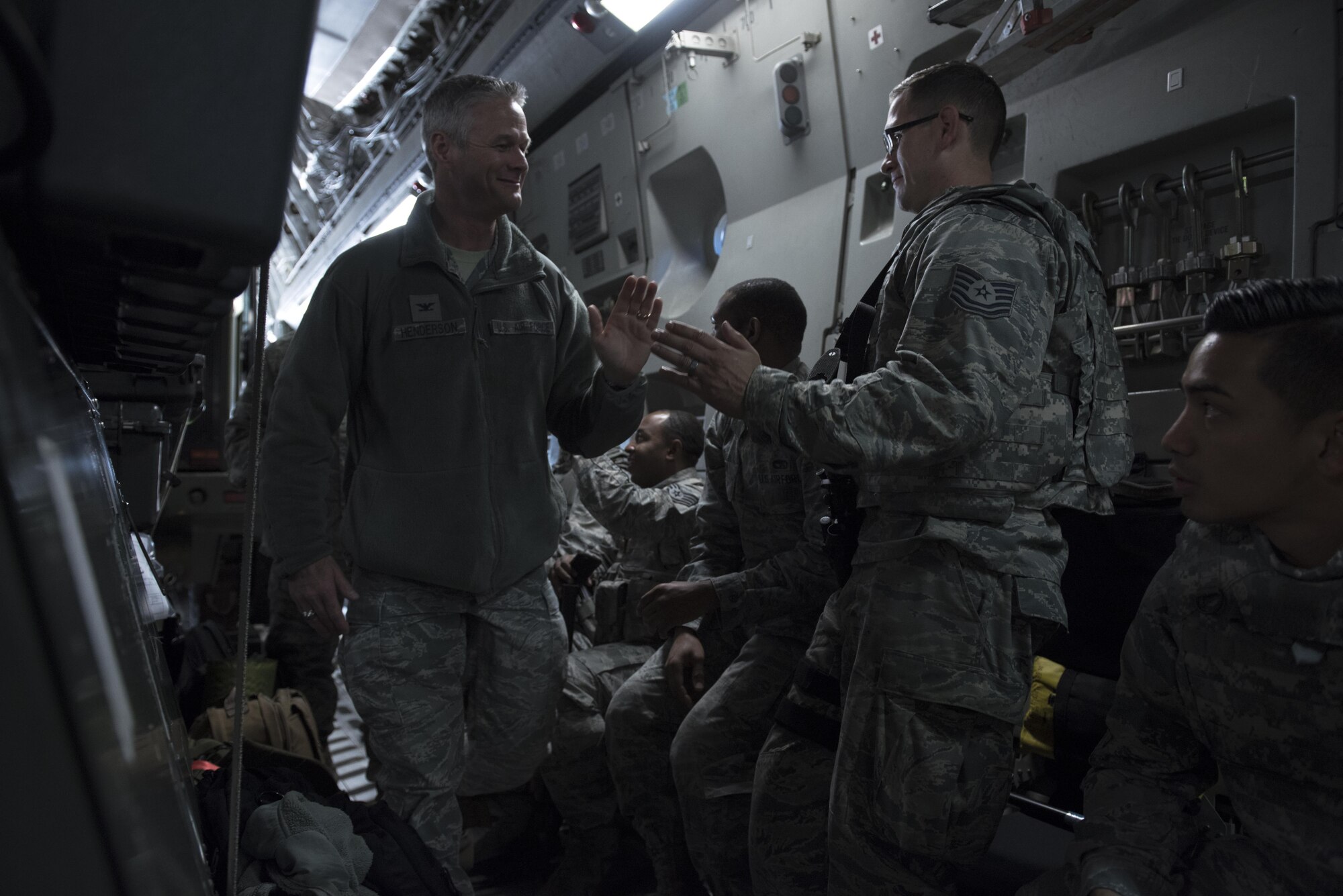 Col. Charles Henderson, 621st Contingency Response Wing commander, high-fives Tech. Sgt. Scott Carlson, 621st Contingency Response Squadron defender October 6, 2016 at Joint Base McGuire-Dix-Lakehurst, N.J. Henderson was present to support more than 30 members of the 621st CRW on their way to Port-au-Prince, Haiti in response to Hurricane Matthew, October 6, 2016. Once on the ground, the CRW will provide assistance by facilitating the movement of humanitarian aid and cargo. 