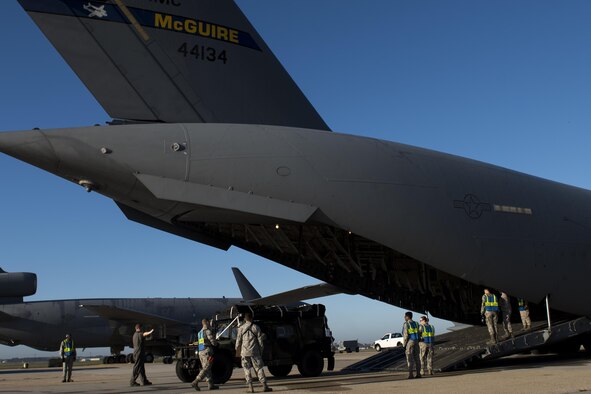 Airmen from the 6th Airlift Squadron and the 305th Aerial Port Squadron load a Humvee onto a C-17 Globemaster III at Joint Base McGuire-Dix-Lakehurst, N.J., Oct. 6, 2016. Mission partners on base provided the 621st Contingency Response Wing with mobility support as they sent more than 30 Airmen to Haiti in support of disaster relief operations in response to Hurricane Matthew. (U.S. Air Force photo/Airman 1st Class Zachary Martyn)
