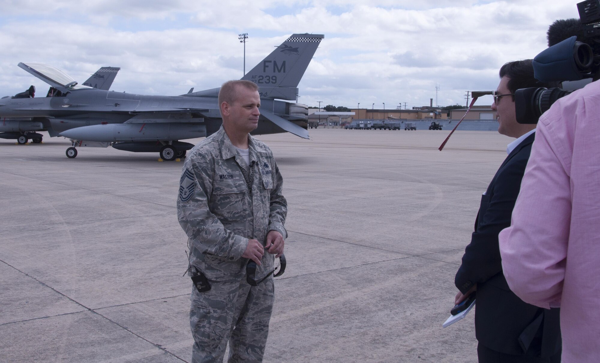 Chief Master Sgt. Stacy Walker, 482nd Fighter Wing Aircraft Maintenance superintendent, speaks with a CBS 11 news crew Oct. 6, 2016, at Naval Air Station Fort Worth Joint Reserve Base, Texas. Walker was interviewed about the relocation of F-16 Fighting Falcons from Homestead Air Reserve Base, Fla., here due to Hurricane Matthew. (U.S. Air Force photo by Tech. Sgt. Melissa Harvey)