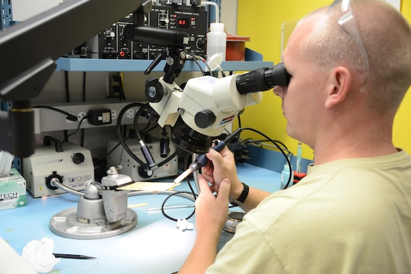 U.S. Air Force Tech Sgt. Dustin Burgess, 57th Maintenance Group Air Force repair enhancement program technician, works on an assignment for the Miniature and Microminiature (2M) Circuit Card Repair course at Davis-Monthan Air Force Base, Ariz., Oct. 3, 2016.  Burgess is stationed at Nellis AFB, Nev., but was sent to the 372nd Training Squadron, Detachment 11, to complete the 2M course. (U.S. Air Force photo by Senior Airman Betty R. Chevalier)