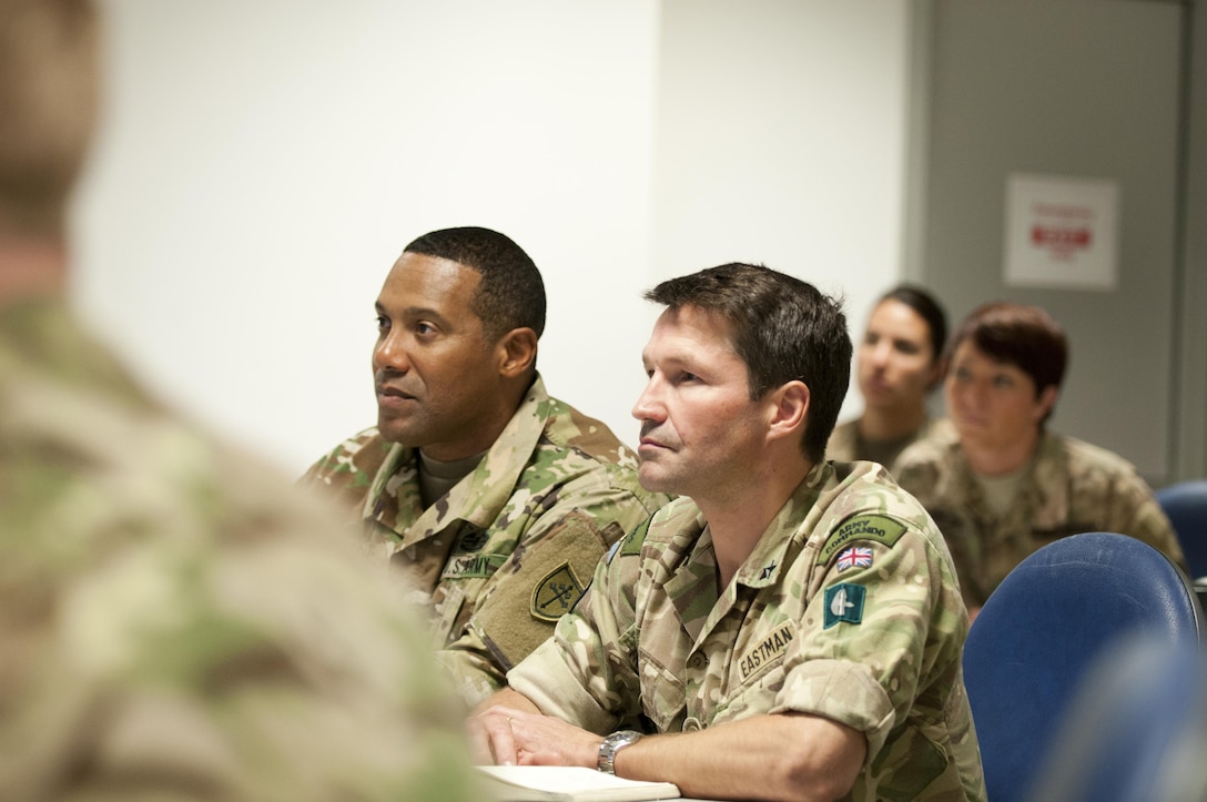 British army Brig. Gen. David Eastman, commanding general of the 102 Logistic Brigade, right, and Col. Vincent Buggs, 79th Sustainment Command (Support) Supports Operation Officer, left, attend a shift change briefing during Exercise Lion Focus '16 Sept. 20, 2016, in Vicenza, Italy. (U.S. Army photo by Sgt. 1st Class Alexandra Hays, 79th Sustainment Command (Support).
