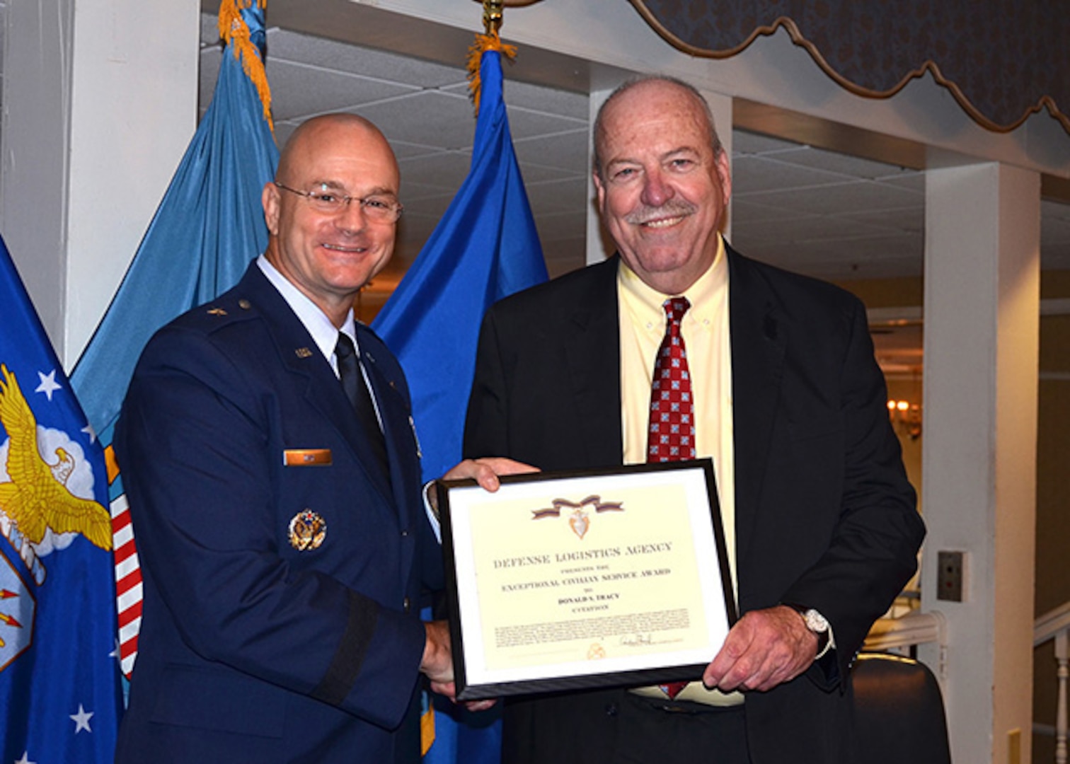 Defense Logistics Agency Aviation and Defense Supply Center Richmond, Virginia Commander Air Force Brig. Gen. Allan Day presents Deputy Chief Counsel Don Tracy, Defense Logistics Agency Counsel – Aviation with the Exceptional Civilian Service Award during Tracy’s retirement ceremony Sept. 29, 2016, at the historic Bellwood Club on DSCR. 